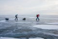male hikers with backpacks walking on ice water surface during daytime,,russia, lake